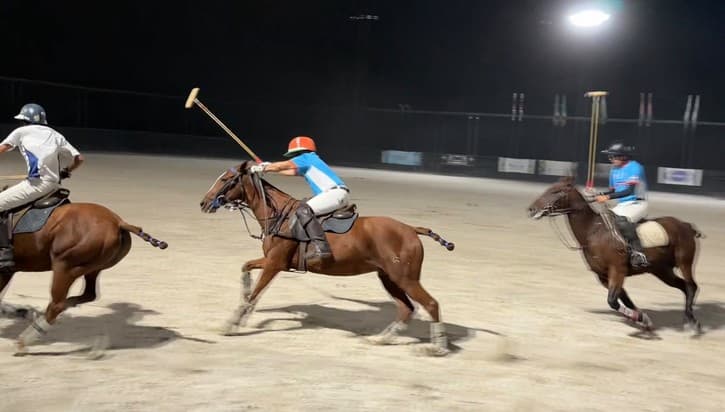 Chaitania Kumar rides off a Commonwealth player under arena lights